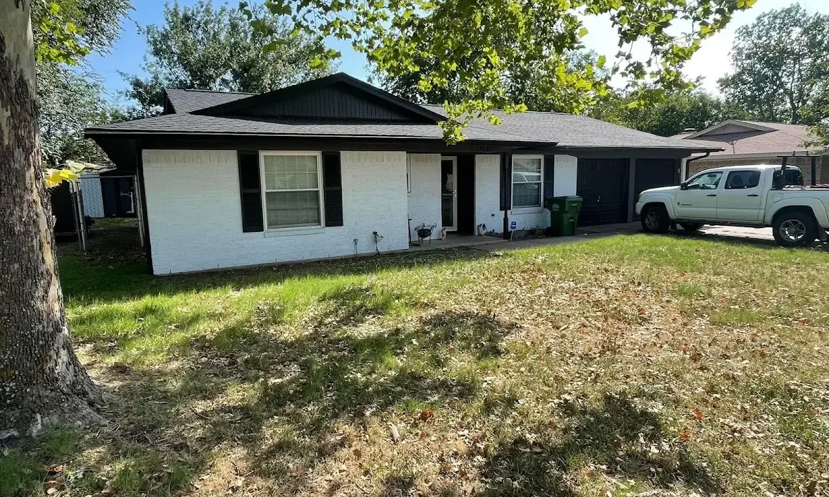 Professional roofing crew working on a residential roof in Clemmons
